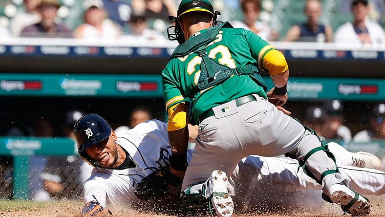 Sep 2, 2021; Detroit, Michigan, USA;  Oakland Athletics catcher Yan Gomes (23) tags Detroit Tigers center fielder Victor Reyes (22) out at home in the third inning at Comerica Park. Mandatory Credit: Rick Osentoski-USA TODAY Sports