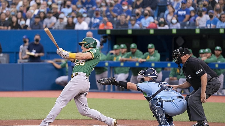 Sep 3, 2021; Toronto, Ontario, CAN; Oakland Athletics third baseman Matt Chapman (26) hits a two run double during the first inning against the Toronto Blue Jays at Rogers Centre. Mandatory Credit: Nick Turchiaro-USA TODAY Sports