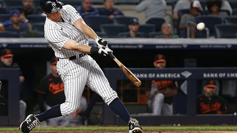 Sep 3, 2021; Bronx, New York, USA; New York Yankees second baseman DJ LeMahieu (26) drives in a run with a sacrifice fly against the Baltimore Orioles during the fifth inning at Yankee Stadium. Mandatory Credit: Andy Marlin-USA TODAY Sports