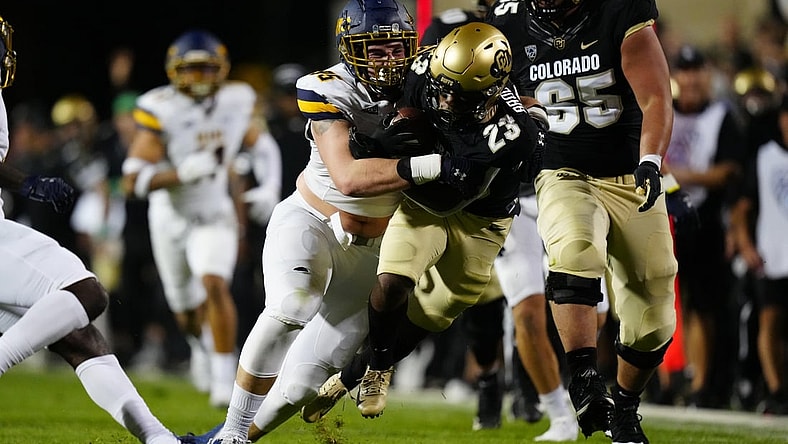 Sep 3, 2021; Boulder, Colorado, USA; Northern Colorado Bears defensive lineman Joe Golden (95) tackles Colorado Buffaloes running back Jarek Broussard (23) after a thirty yard carry n the second quarter at Folsom Field. Mandatory Credit: Ron Chenoy-USA TODAY Sports