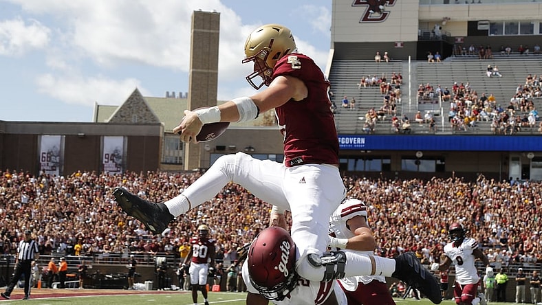 Sep 4, 2021; Chestnut Hill, Massachusetts, USA; Boston College Eagles tight end Trae Barry (3) hurdles Colgate Raiders defensive back Keshaun Dancy (20) for a touchdown during the first half at Alumni Stadium. Mandatory Credit: Winslow Townson-USA TODAY Sports