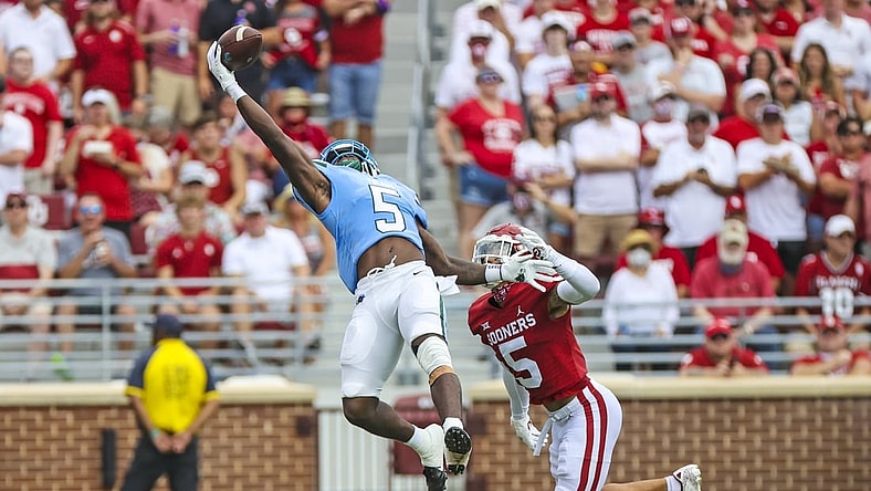 Sep 4, 2021; Norman, Oklahoma, USA;  Tulane Green Wave running back Ygenio Booker (5) makes a leaping catch in front of Oklahoma Sooners defensive back Billy Bowman (5) during the first quarter at Gaylord Family-Oklahoma Memorial Stadium. Mandatory Credit: Kevin Jairaj-USA TODAY Sports