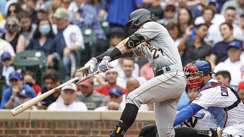 Sep 4, 2021; Chicago, Illinois, USA; Pittsburgh Pirates shortstop Kevin Newman (27) singles against the Chicago Cubs as he breaks his bat during the fourth inning at Wrigley Field. Mandatory Credit: Kamil Krzaczynski-USA TODAY Sports