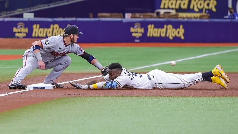 Sep 4, 2021; St. Petersburg, Florida, USA; Tampa Bay Rays left fielder Randy Arozarena (56) slides into third base against Minnesota Twins third baseman Josh Donaldson (20) during the first inning at Tropicana Field. Mandatory Credit: Mike Watters-USA TODAY Sports