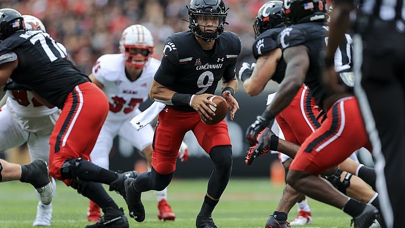Sep 4, 2021; Cincinnati, Ohio, USA; Cincinnati Bearcats quarterback Desmond Ridder (9) tosses the ball against the Miami (Oh) Redhawks in the first half at Nippert Stadium. Mandatory Credit: Aaron Doster-USA TODAY Sports
