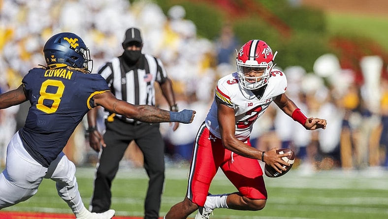 Sep 4, 2021; College Park, Maryland, USA; Maryland Terrapins quarterback Taulia Tagovailoa (3) escapes the pocket and pressure from West Virginia Mountaineers linebacker VanDarius Cowan (8) during the second quarter at Capital One Field at Maryland Stadium. Mandatory Credit: Ben Queen-USA TODAY Sports