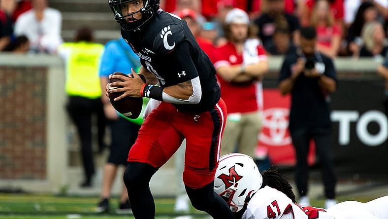Cincinnati Bearcats quarterback Desmond Ridder (9) is sacked by Miami Redhawks defensive lineman Lonnie Phelps (47) in the second half of the NCAA football game on Saturday, Sept. 4, 2021, at Nippert Stadium in Cincinnati. Cincinnati Bearcats defeated Miami Redhawks 49-14.

Cincinnati Bearcats Miami Redhawks