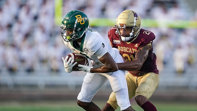 Sep 4, 2021; San Marcos, Texas, USA;  Baylor Bears wide receiver Tyquan Thornton (9) runs the ball against Texas State Bobcats cornerback Michael LoVett III (21) in the second quarter at Bobcat Stadium. Mandatory Credit: Daniel Dunn-USA TODAY Sports