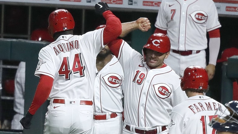Sep 4, 2021; Cincinnati, Ohio, USA; Cincinnati Reds left fielder Aristides Aquino (44) reacts with first baseman Joey Votto (19) after hitting a three run home run against the Detroit Tigers during the third inning at Great American Ball Park. Mandatory Credit: David Kohl-USA TODAY Sports