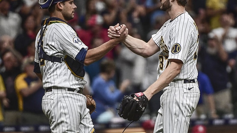 Sep 4, 2021; Milwaukee, Wisconsin, USA;  Milwaukee Brewers pitcher Adrian Houser (37) celebrates with catcher Luke Maile (12) after pitching a complete game shutout to beat the St. Louis Cardinals at American Family Field. Mandatory Credit: Benny Sieu-USA TODAY Sports