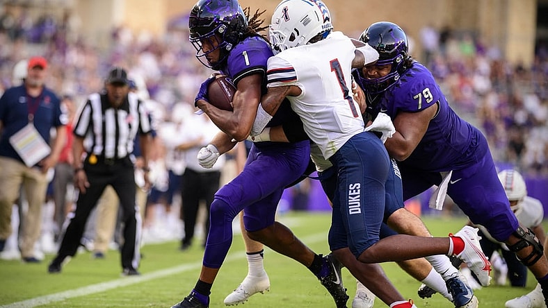 Sep 4, 2021; Fort Worth, Texas, USA; TCU Horned Frogs wide receiver Quentin Johnston (1) is tackled by Duquesne Dukes defensive back Jeremiah Josephs (1) during the first quarter at Amon G. Carter Stadium. Mandatory Credit: Jerome Miron-USA TODAY Sports