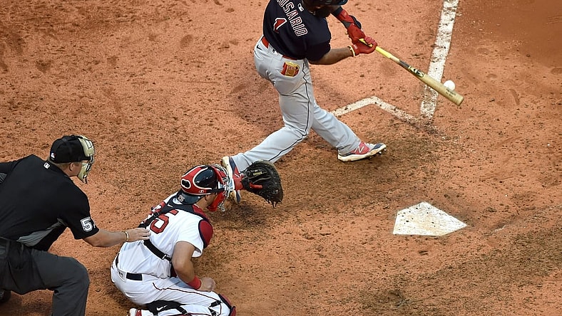 Sep 5, 2021; Boston, Massachusetts, USA;  Cleveland Indians shortstop Amed Rosario (1) hits an RBI single during the ninth inning against the Boston Red Sox at Fenway Park. Mandatory Credit: Bob DeChiara-USA TODAY Sports
