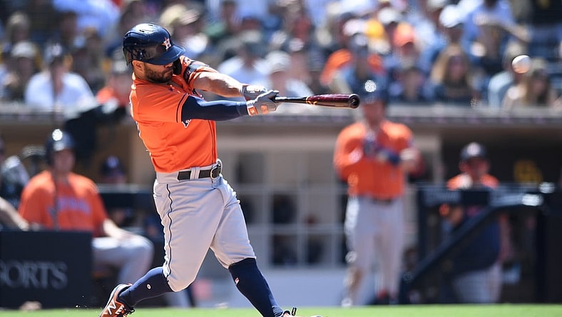 Sep 5, 2021; San Diego, California, USA; Houston Astros second baseman Jose Altuve (27) hits a single against the San Diego Padres during the sixth inning at Petco Park. Mandatory Credit: Orlando Ramirez-USA TODAY Sports