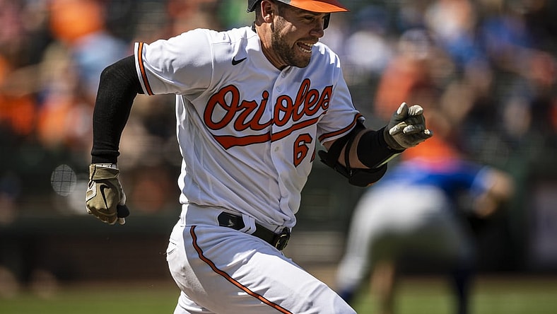 Sep 6, 2021; Baltimore, Maryland, USA; Baltimore Orioles catcher Austin Wynns (61) sprints to beat the throw to first base against the Kansas City Royals during the third inning at Oriole Park at Camden Yards. Mandatory Credit: Scott Taetsch-USA TODAY Sports