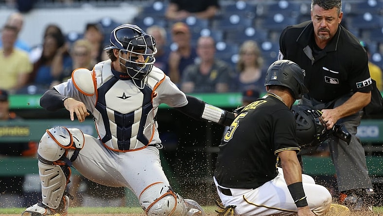 Sep 7, 2021; Pittsburgh, Pennsylvania, USA;  Detroit Tigers catcher Eric Haase (13) tags Pittsburgh Pirates catcher Michael Perez (5) out at home plate attempting to score during the second inning at PNC Park. Mandatory Credit: Charles LeClaire-USA TODAY Sports