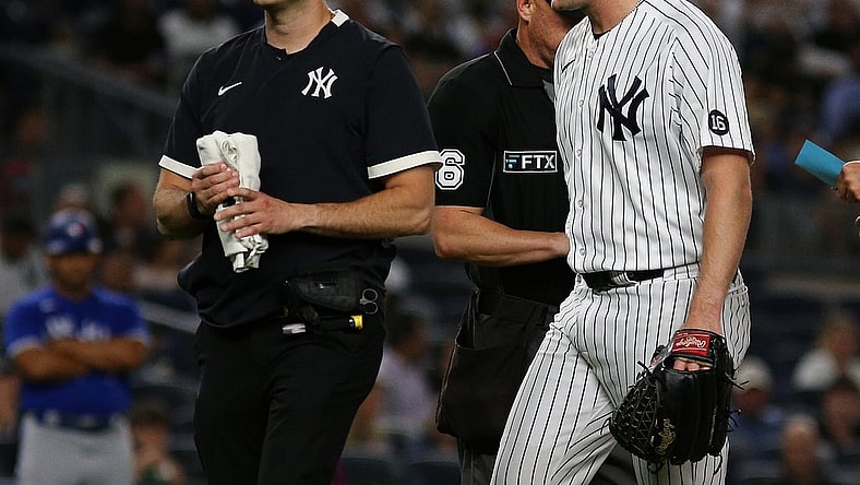 Sep 7, 2021; Bronx, New York, USA; New York Yankees starting pitcher Gerrit Cole (45) leaves the field with the trainer against the Toronto Blue Jays during the fourth inning at Yankee Stadium. Mandatory Credit: Andy Marlin-USA TODAY Sports