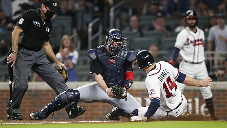 Sep 7, 2021; Atlanta, Georgia, USA; Washington Nationals catcher Riley Adams (25) tags out Atlanta Braves left fielder Adam Duvall (14) at the plate in the third inning at Truist Park. Mandatory Credit: Brett Davis-USA TODAY Sports
