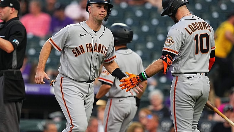 Sep 7, 2021; Denver, Colorado, USA; San Francisco Giants catcher Buster Posey (28) celebrates scoring a run with third baseman Evan Longoria (10) in the first inning against the Colorado Rockies at Coors Field. Mandatory Credit: Ron Chenoy-USA TODAY Sports
