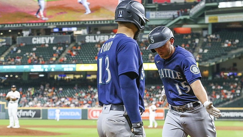 Sep 7, 2021; Houston, Texas, USA; Seattle Mariners second baseman Abraham Toro (13) celebrates a home run hit by third baseman Kyle Seager (15) against the Houston Astros in the sixth inning at Minute Maid Park. Mandatory Credit: Thomas Shea-USA TODAY Sports
