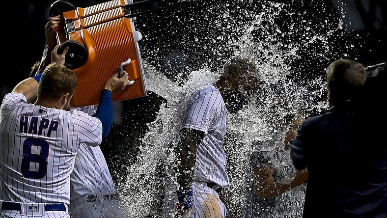 Sep 8, 2021; Chicago, Illinois, USA; Chicago Cubs right fielder Jason Heyward (22) gets doused by Chicago Cubs center fielder Ian Happ (8) after hitting a walk off three run home run against the Cincinnati Reds during the tenth inning at Wrigley Field. Mandatory Credit: Matt Marton-USA TODAY Sports