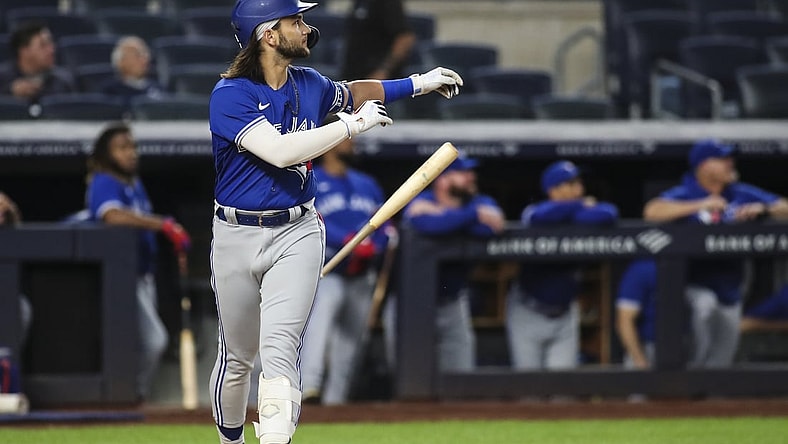 Sep 9, 2021; Bronx, New York, USA; Toronto Blue Jays shortstop Bo Bichette (11) flips his bat after hitting a leadoff solo home run against the New York Yankees in the first inning at Yankee Stadium. Mandatory Credit: Wendell Cruz-USA TODAY Sports