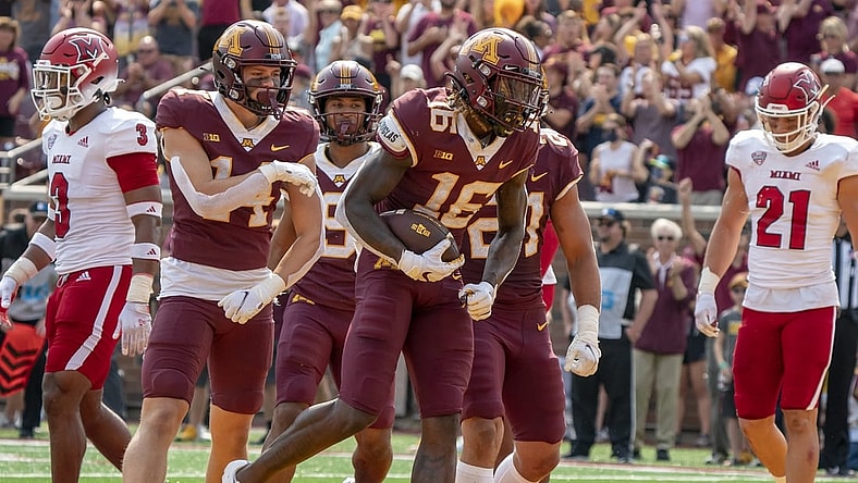 Sep 11, 2021; Minneapolis, Minnesota, USA; Minnesota Golden Gophers wide receiver Dylan Wright (16) scores in the second quarter, congratulated by teammates wide receiver Brady Boyd (14), wide receiver Daniel Jackson (9) and Minnesota Golden Gophers running back Bryce Williams (21) at Huntington Bank Stadium. Mandatory Credit: Matt Blewett-USA TODAY Sports