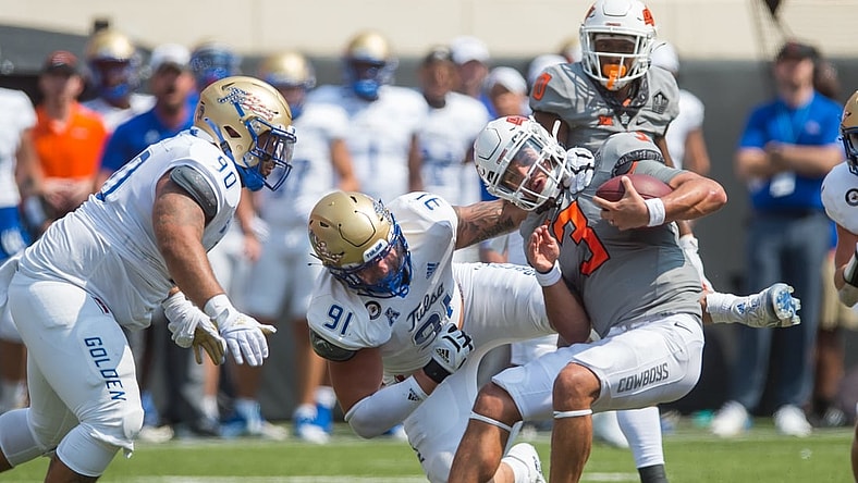 Sep 11, 2021; Stillwater, Oklahoma, USA;  Oklahoma State Cowboys quarterback Spencer Sanders (3) is sacked by Tulsa Golden Hurricane defensive lineman Cullen Wick (91) as defensive lineman Jaxon Player (90) moves in during the second quarter  at Boone Pickens Stadium. Mandatory Credit: Brett Rojo-USA TODAY Sports