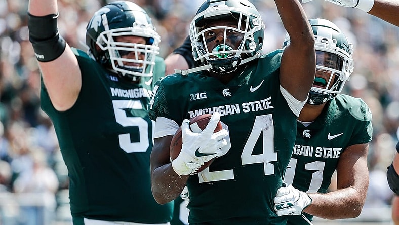Michigan State running back Elijah Collins (24) celebrates a touchdown against Youngstown State during the first half at Spartan Stadium in East Lansing on Saturday, Sept. 11, 2021.