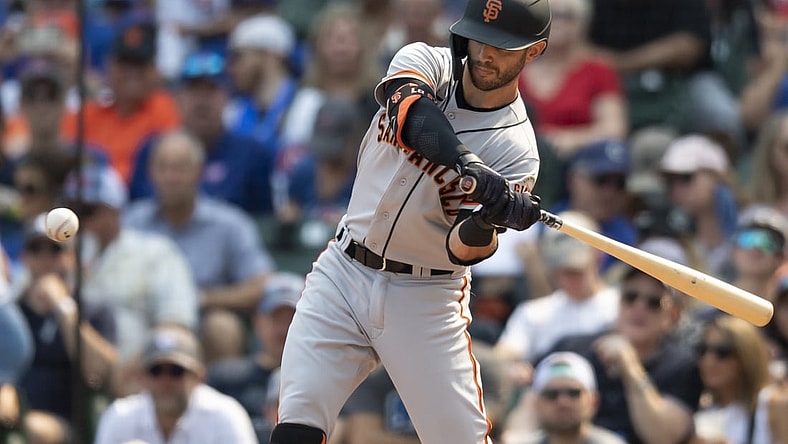 Sep 11, 2021; Chicago, Illinois, USA; San Francisco Giants second baseman Tommy La Stella (18) hits a two RBI single during the second inning against the Chicago Cubs at Wrigley Field. Mandatory Credit: Patrick Gorski-USA TODAY Sports