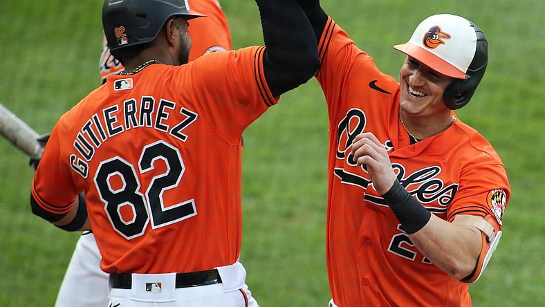 Sept. 11, 2021; Baltimore, Maryland, USA; Baltimore Orioles right fielder Austin Hays (21) celebrates with Baltimore Orioles third baseman Kelvin Gutierrez (82) after hitting a home run during the third inning against the Toronto Blue Jays at Oriole Park at Camden Yards. Mandatory Credit: Daniel Kucin Jr.-USA TODAY Sports
