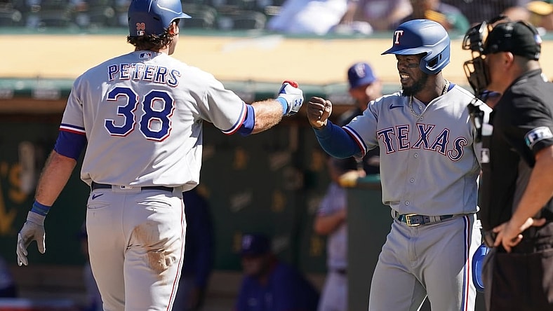 Sep 11, 2021; Oakland, California, USA; Texas Rangers left fielder DJ Peters (38) is congratulated by right fielder Adolis Garcia (53) after hitting a home run during the eighth inning against the Oakland Athletics at RingCentral Coliseum. Mandatory Credit: Darren Yamashita-USA TODAY Sports