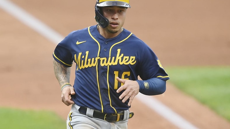 Sep 11, 2021; Cleveland, Ohio, USA; Milwaukee Brewers second baseman Kolten Wong (16) scores in the first inning against the Cleveland Indians at Progressive Field. Mandatory Credit: David Richard-USA TODAY Sports