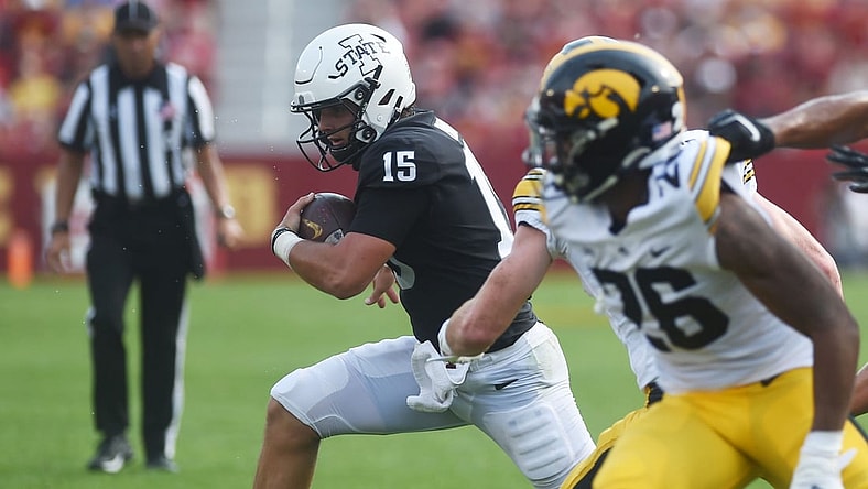 Iowa State's quarterback Brock Purdy runs with the ball around Iowa's defensive back Kaevon Merriweather during the first quarter in the Cy-Hawk series at Jack Trice Stadium Saturday, Sept. 11, 2021, in Ames, Iowa.
