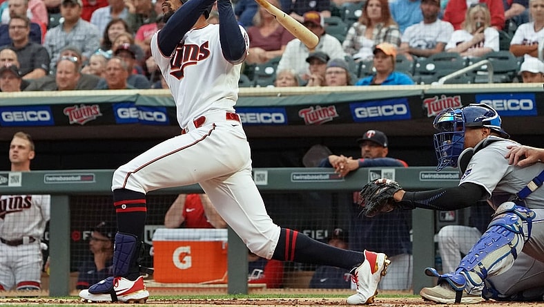 Sep 11, 2021; Minneapolis, Minnesota, USA;  Minnesota Twins outfielder Byron Buxton (25) hits a solo home run off of Kansas City Royals starting pitcher Brady Singer (51) during the first inning at Target Field. Mandatory Credit: Nick Wosika-USA TODAY Sports