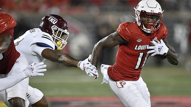 Sep 11, 2021; Louisville, Kentucky, USA;  Louisville Cardinals wide receiver Josh Johnson (11) runs the ball past the reach of Eastern Kentucky Colonels linebacker Je'Vari Anderson (14) during the second quarter at Cardinal Stadium. Mandatory Credit: Jamie Rhodes-USA TODAY Sports