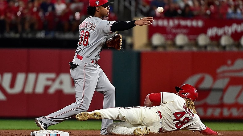 Sep 11, 2021; St. Louis, Missouri, USA;  Cincinnati Reds shortstop Jose Barrero (38) turns a double play as St. Louis Cardinals center fielder Harrison Bader (48) slides during the fifth inning at Busch Stadium. Mandatory Credit: Jeff Curry-USA TODAY Sports