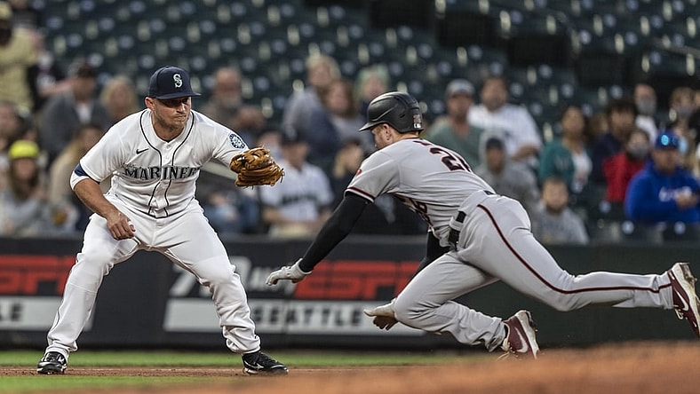 Sep 11, 2021; Seattle, Washington, USA;  Seattle Mariners third baseman Kyle Seager (15) tags out Arizona Diamondbacks first baseman Pavin Smith (26) after Smith tagged up on a fly ball during the fourth inning at T-Mobile Park. Mandatory Credit: Stephen Brashear-USA TODAY Sports