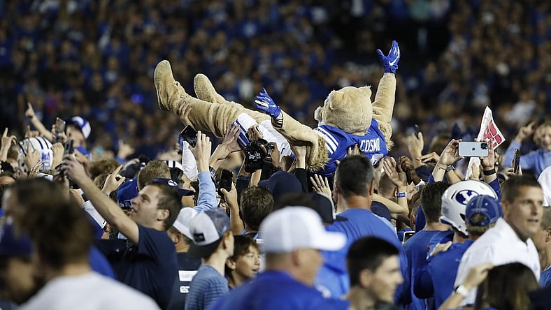Sep 11, 2021; Provo, Utah, USA; Brigham Young Cougars mascot Cosmo body surfs as fans stormed the field after their win over the Utah Utes at LaVell Edwards Stadium. Mandatory Credit: Jeffrey Swinger-USA TODAY Sports