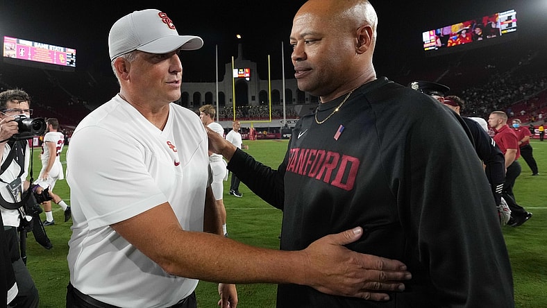 Sep 11, 2021; Los Angeles, California, USA; Southern California Trojans head coach Clay Helton and Stanford Cardinal head coach David Shaw shake hands after a game at United Airlines Field at Los Angeles Memorial Coliseum. Mandatory Credit: Kirby Lee-USA TODAY Sports