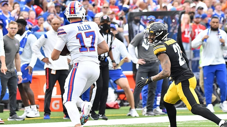 Sep 12, 2021; Orchard Park, New York, USA; Buffalo Bills quarterback Josh Allen (17) tries to outrun Pittsburgh Steelers cornerback Tre Norwood (21) in the first quarter of a game at Highmark Stadium. Mandatory Credit: Mark Konezny-USA TODAY Sports