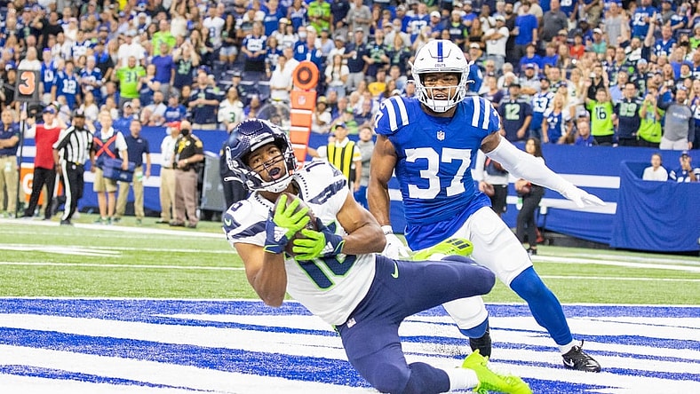 Sep 12, 2021; Indianapolis, Indiana, USA; Seattle Seahawks wide receiver Tyler Lockett (16) catches a touchdown pass while Indianapolis Colts safety Khari Willis (37) defends in the first quarter at Lucas Oil Stadium. Mandatory Credit: Trevor Ruszkowski-USA TODAY Sports