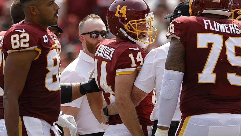 Sep 12, 2021; Landover, Maryland, USA; Washington Football Team quarterback Ryan Fitzpatrick (14) is helped off the field after being inured against the Los Angeles Chargers in the second quarter at FedExField. Mandatory Credit: Geoff Burke-USA TODAY Sports