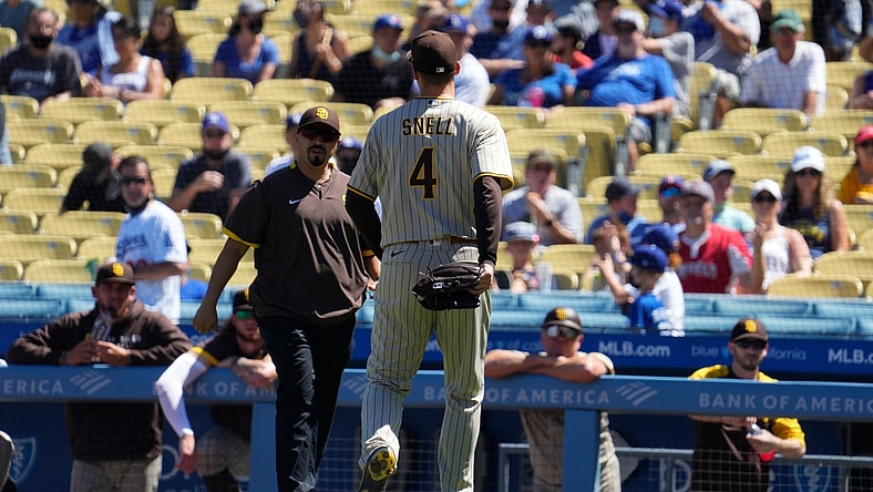 Sep 12, 2021; Los Angeles, California, USA; San Diego Padres trainer walks out of the dugout to meet San Diego Padres starting pitcher Blake Snell (4) after Snell injured himself throwing a pitch in the first inning against the Los Angeles Dodgers at Dodger Stadium. Mandatory Credit: Robert Hanashiro-USA TODAY Sports