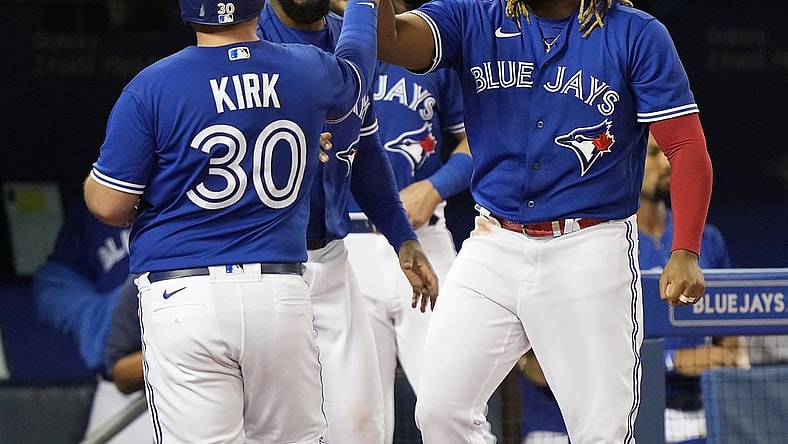 Sep 13, 2021; Toronto, Ontario, CAN; Toronto Blue Jays first baseman Vladimir Guerrero Jr (27) congratulates catcher Alejandro Kirk (30) on scoring against the Tampa Bay Rays in the fourth inning at Rogers Centre. Mandatory Credit: John E. Sokolowski-USA TODAY Sports