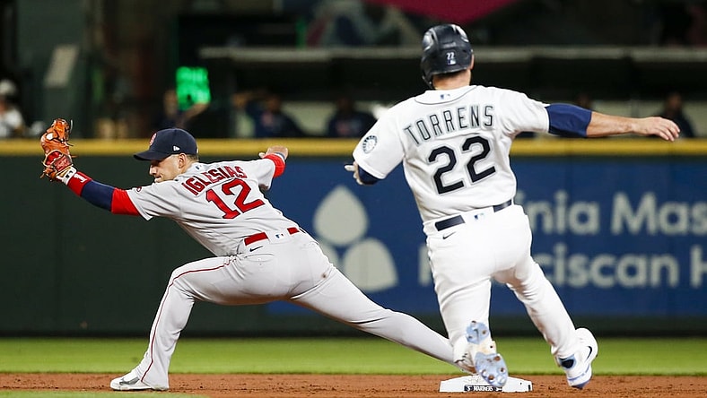 Sep 13, 2021; Seattle, Washington, USA; Boston Red Sox second baseman Jose Iglesias (12) reaches for a force out against the Seattle Mariners during the second inning at T-Mobile Park. Mandatory Credit: Joe Nicholson-USA TODAY Sports