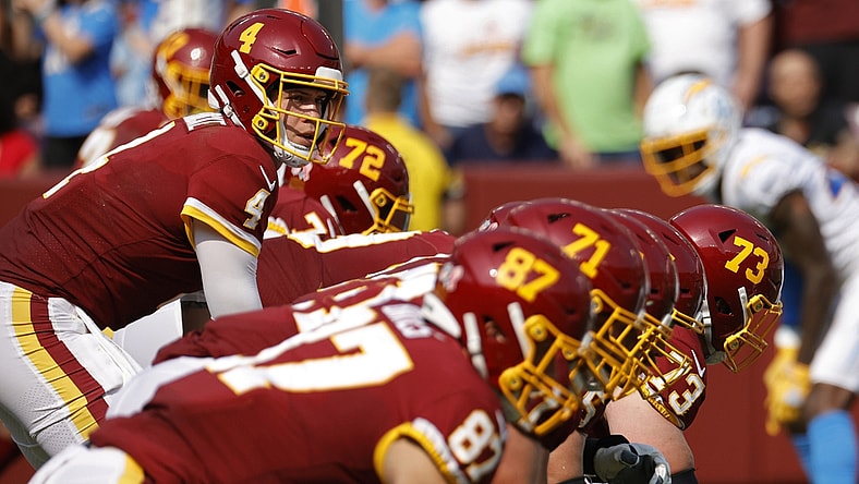 Sep 12, 2021; Landover, Maryland, USA; Washington Football Team quarterback Taylor Heinicke (4) lines up under center Washington Football Team center Chase Roullier (73) against the Los Angeles Chargers at FedExField. Mandatory Credit: Geoff Burke-USA TODAY Sports