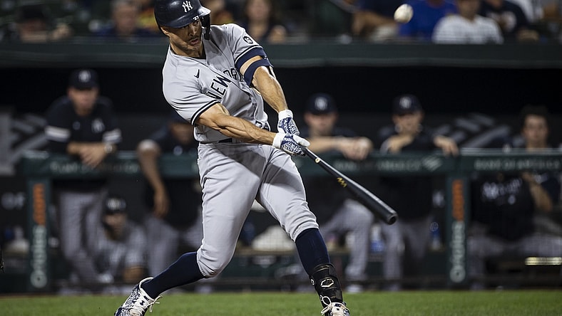 Sep 14, 2021; Baltimore, Maryland, USA; New York Yankees left fielder Giancarlo Stanton (27) hits a two run home run against the Baltimore Orioles during the third inning at Oriole Park at Camden Yards. Mandatory Credit: Scott Taetsch-USA TODAY Sports