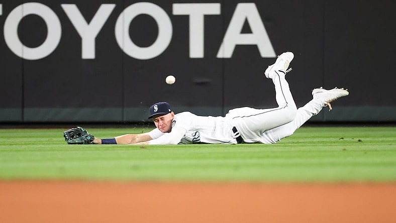 Sep 14, 2021; Seattle, Washington, USA;  Seattle Mariners center fielder Jarred Kelenic (10) is unable to make the catch for a hit off the bat of Boston Red Sox shortstop Jose Iglesias (12) in the fifth inning at T-Mobile Park. Mandatory Credit: Abbie Parr-USA TODAY Sports