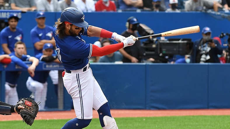 Sep 15, 2021; Toronto, Ontario, CAN;  Toronto Blue Jays shortstop Bo Bichette (11) hits a three run home run against Tampa Bay Rays in the first inning at Rogers Centre. Mandatory Credit: Dan Hamilton-USA TODAY Sports