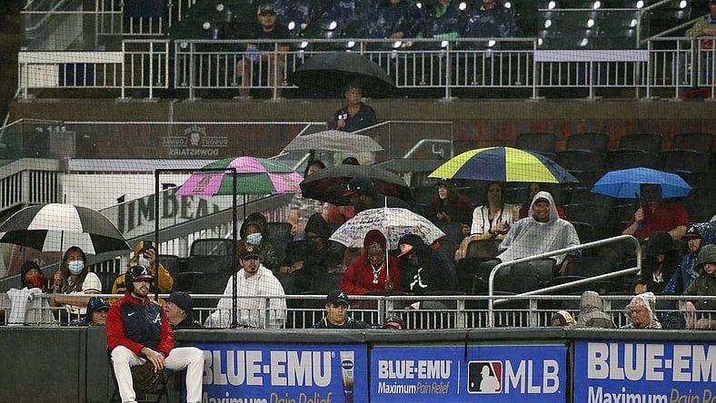 Sep 15, 2021; Atlanta, Georgia, USA; Fans watch a game between the Atlanta Braves and Colorado Rockies with umbrellas in the rain in the second inning at Truist Park. Mandatory Credit: Brett Davis-USA TODAY Sports